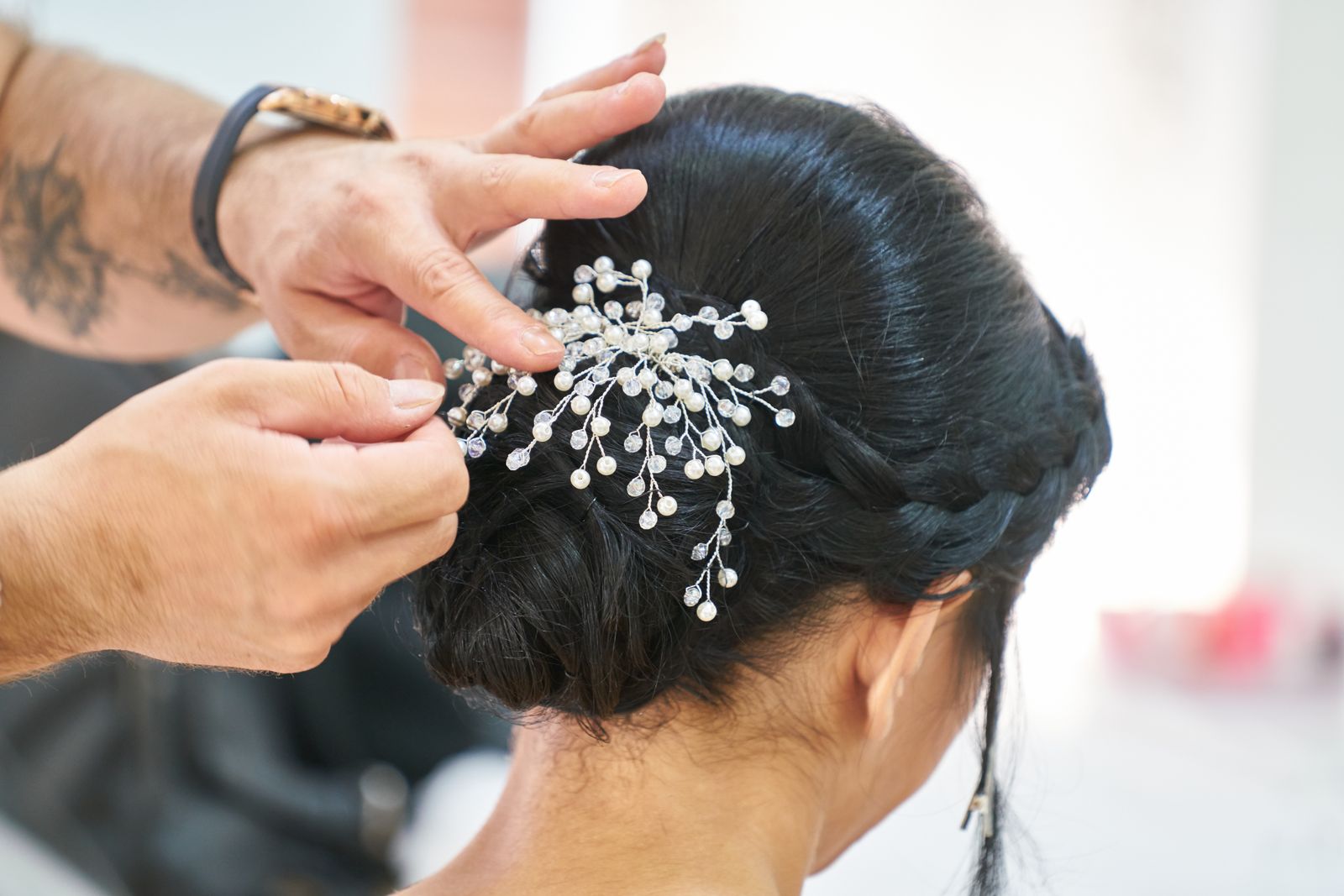 A pearl pin set into a sleek low updo