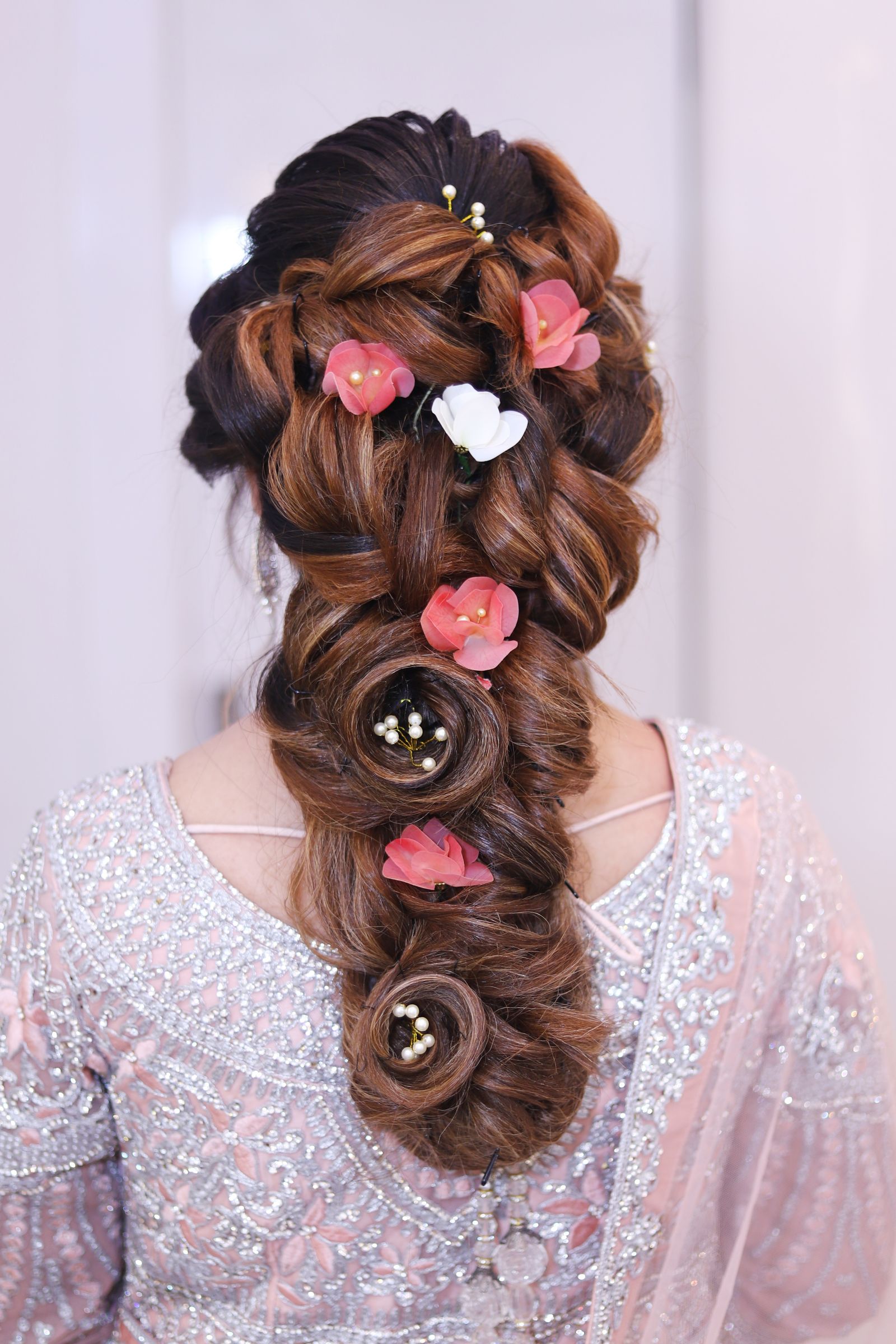 Braided special-occasion updo with floral pins